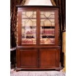 An early Victorian mahogany Bookcase, with dentil moulded cornice above astragal glazed doors,