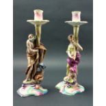 An attractive pair of 19th Century Continental polychrome porcelain figural Candlesticks,