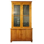 A 19th Century Biedermeier tall Bookcase or Display Cabinet, the moulded top glazed panelled doors,