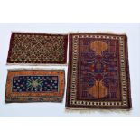 A Baluch Rug, North West Afghanistan, the dark blue and red field with stylized pattern,