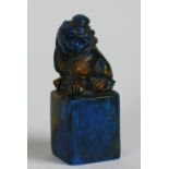A Chinese carved hard stone Seal, in Lapis Lazuli colour with mythical beast surmounted, 3" (7.