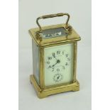 A 19th Century brass French Carriage Clock, open escapement and swivel carrying handle,