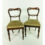 A pair of Victorian rosewood carved Side Chairs, with open backs drop in upholstered seats,