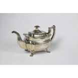 An elegant engraved Irish silver Teapot, of bulbous rectangular shape, with box handle and spout,