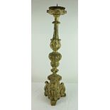A tall antique carved wooden Pricket Candlestick, the silvered body on scrolled tri-form base,