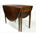 A small 19th Century mahogany Dining Table, the two falling leaves opening to form an oval table,