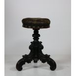 A Victorian telescopic mahogany Piano Stool, with leather seat on ornate carved tripod base.