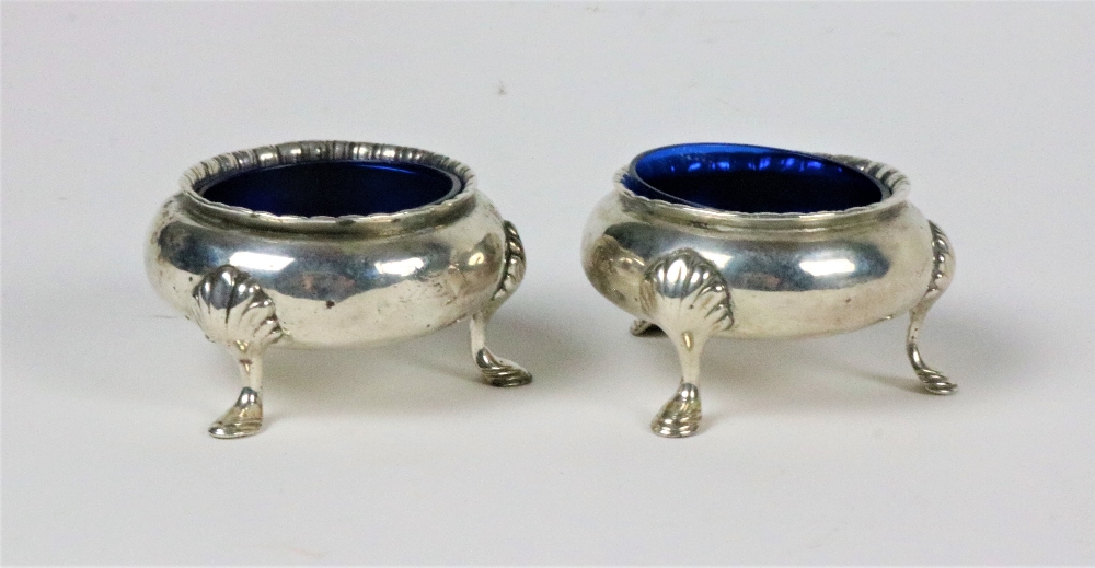 A pair of Victorian silver Salts, with gadroon edge on shell decorated pad feet, with liners,