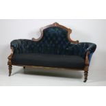 A Victorian inlaid walnut Settee, with arched and button back and padded seat on turned front legs,