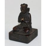 A Chinese bronze Buddha Seal, sitting with legs crossed,