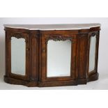 A Victorian walnut Credenza, with white marble top above three mirror doors on a shaped plinth base,