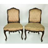 A pair of 19th Century French carved walnut Parlour Chairs, with upholstered backs and seats,