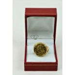 A half Sovereign 1906 (King Edward), mounted in a plain gold clasp Ring.