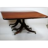 A large Regency period mahogany twin pedestal Dining Table, with two spare leaves,