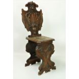 An unusual 19th Century carved oak shield shaped Side Chair, decorated with shells, fruit etc.