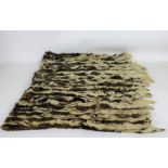Taxidermy: A large Rug, with multiple skunk fur skins attached, approx. 259cms (102").