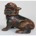A heavy bronze, gilt bronze and red lacquered Fo Dog,