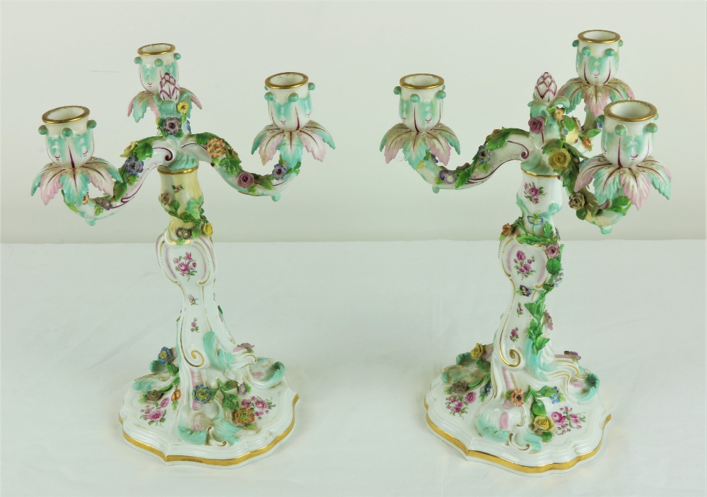 A pair of Meissen three branch Candelabra, with foliate sconces,