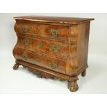 An 18th Century Dutch walnut bombe shaped Commode, the shaped figured top with moulded edge,