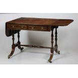 A Regency period brass inlaid mahogany Sofa Table,