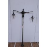 A rare set of three (3) tall chromium plated two branch Gasoliers, 70" high,