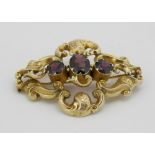 A 9ct gold Brooch, with three rhodolite garnets.