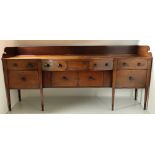 A very fine George III Irish inlaid and figured mahogany bow fronted Sideboard,