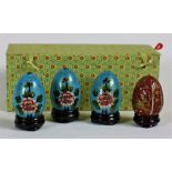 A fine set of 4 colourful Chinese cloisónne Eggs, each with colourful flowers on a lacquered stand,