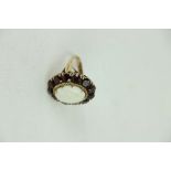An unusual 18ct gold Ladies Ring, with attractive central oval shaped opal stone,