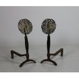 A good heavy pair of brass mounted cast iron Andirons, each with a pierced brass roundel finial,