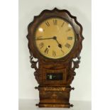 A Victorian inlaid walnut Wall Clock, with caved decoration, and circular dial and Roman numerals.