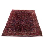 An attractive dark blue and burgundy ground Afghan Carpet,