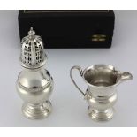 A cased Presentation silver Sugar Castor and Cream Jug, decorated in the Celtic taste, by S.