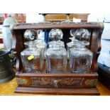 CARVED TANTALUS WITH 3 GLASS DECANTERS 13.5" X 14.75" X 6.5"