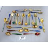 23 ASSORTED ENAMEL SPOONS INCLUDING SILVER