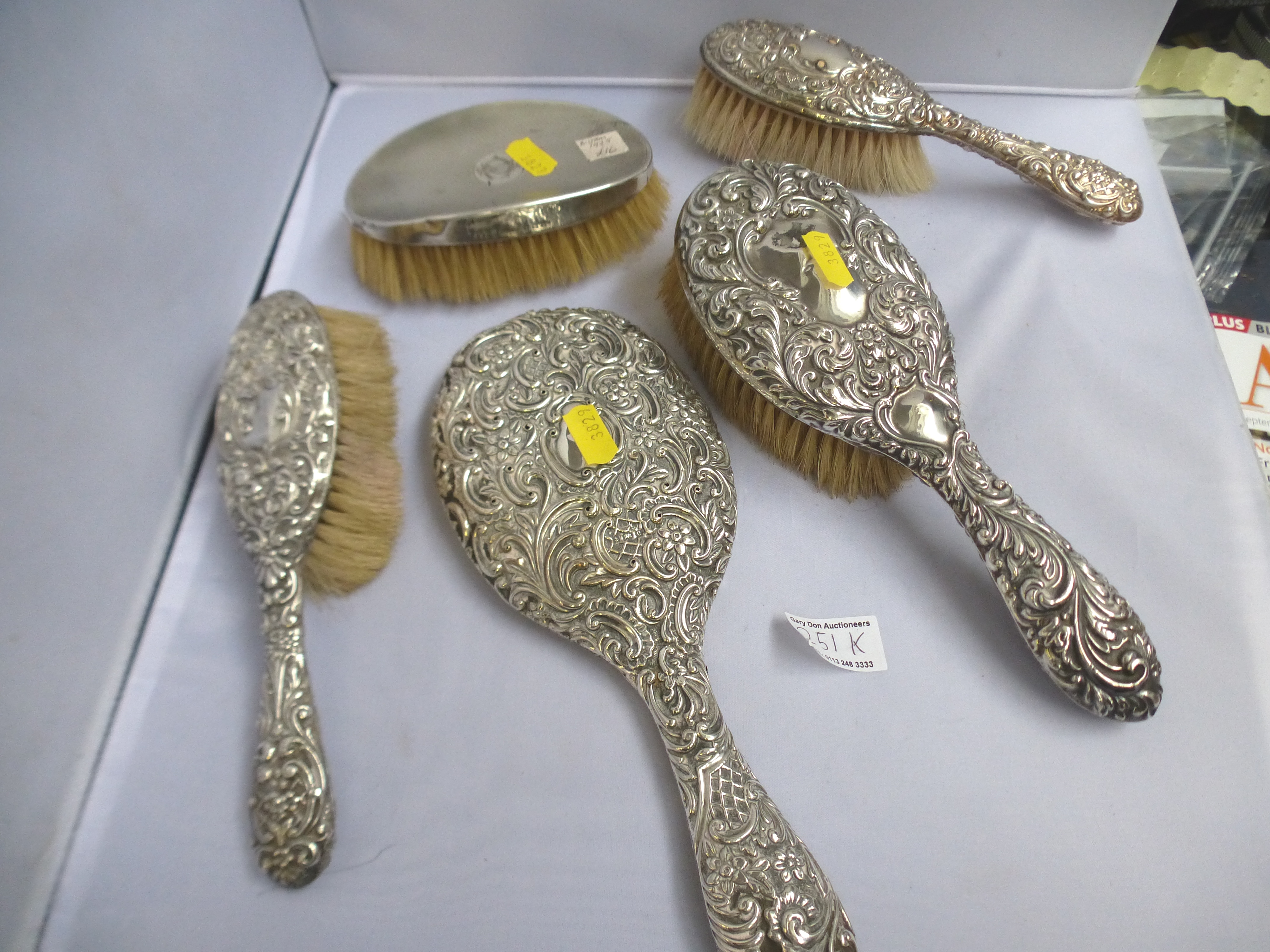 4 SILVER BACK BRUSHES AND A SILVER MIRROR