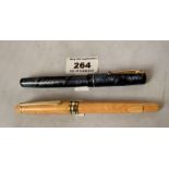 Yellow fountain pen, nib marked Genius, Germany and dark blue fountain pen “Swan Self Filler” with