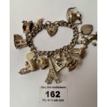 Silver charm bracelet with 14 charms and heart lock, total w: 2.51 ozt, length 7”