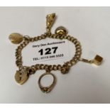 9k gold charm bracelet with 5 charms and heart lock, w: 9.21 grams, length 7”