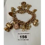 9k gold double link charm, bracelet with 11 charms and heart lock, w: 66.03 grams