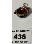 9k gold 3-sided fob with purple, blue and orange stones, total w: 6.85 grams