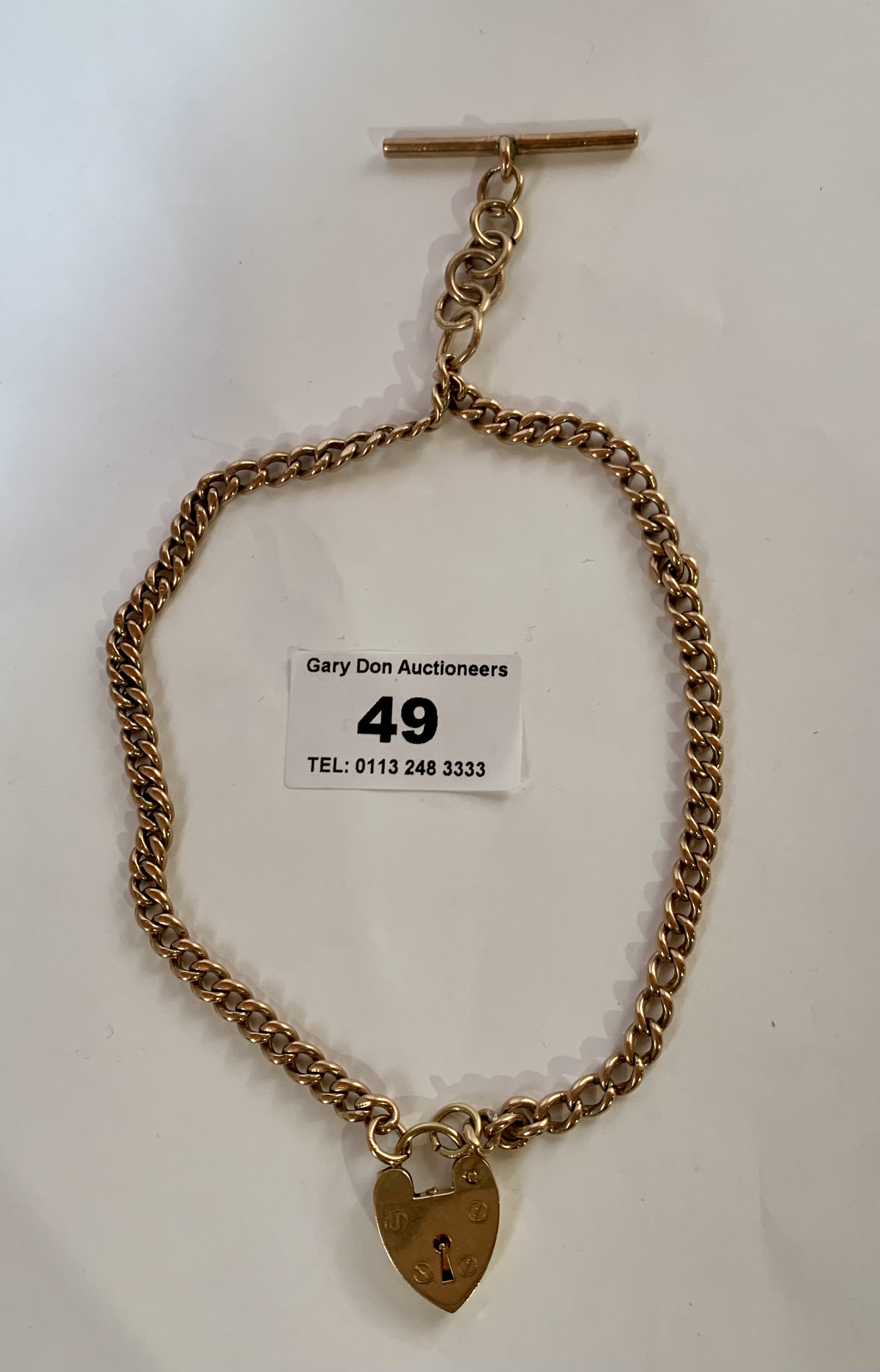 9k gold watch chain with t-bar and heart fastener, w: 30.89 grams, length of chain 16”