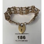 9k gold eight bar cross over link gate bracelet with safety chain and heart lock, w: 18.28 grams,