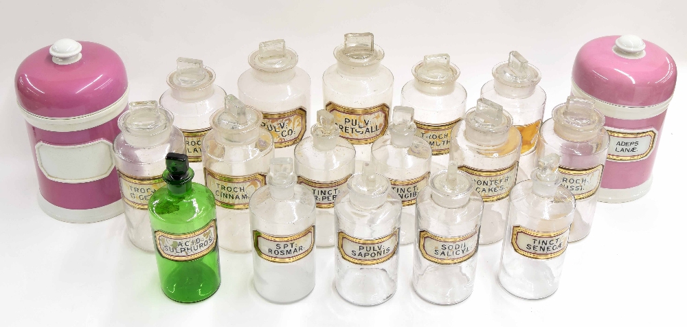 Sixteen Victorian glass apothecary chemist bottles with stoppers, with gilt border labels, (faults),