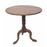 oak circular tilt top tripod table, the plain top over a carved support on cabriole legs, 29"