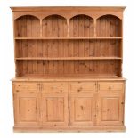 Large stripped pine dresser in the Victorian style, the open Delft rack over four drawers and four