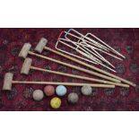Vintage lawn croquet set, with four mallets, six hoops and six balls