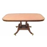 Georgian mahogany dining table, the rectangular crossbanded tilt top upon four turned columns and