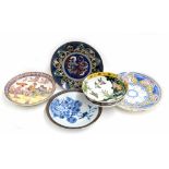 Assorted Oriental pottery chargers including a figural group example 12" diameter, a Japanese