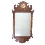 Georgian walnut fret carved wall mirror, surmounted by a gilt highlighted Hoho bird over the